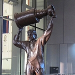 Achievement A statue, located outside Rogers Place in Edmonton, of Gretzky hoisting the Stanley Cup, which the Oilers won four times with him. Sculpted by John Weaver. of Wayne Gretzky