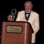 Achievement Clive Cussler is receiving an award. of Clive Cussler