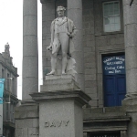 Achievement Statue of Davy in Penzance, Cornwall, holding his safety lamp of Humphry Davy