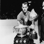 Achievement Gordie Howe of the Detroit Red Wings poses on the ice with the Art Ross and Hart trophies, 1960s.  of Gordie Howe