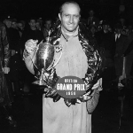 Achievement Juan Manuel Fangio with his cup after winning the British Grand Prix at Silverstone. Photo by Express/Express. of Juan Fangio