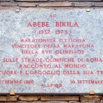 Achievement A plaque on the wall of the Via di San Gregorio, Rome, commemorating the 50th anniversary of Abebe Bikila's first Olympic victory.  of Abebe Bikila