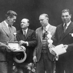 Achievement Gene Tunney (left) and Jack Dempsey (right), the man he won the title from, receive their Championship Belts from the Boxers Writer's Association in New York City. (Left to right) Gene Tunney, Joe Humphries, Wilbur Wood, Jack Dempsey. Photo by the Stanley Weston Archive. of Jack Dempsey
