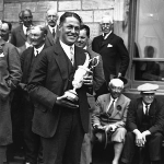 Achievement Bobby Jones holding the trophy after winning the 1927 Open Golf Championship at St. Andrews.  of Bobby Jones