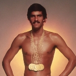 Achievement A poster featuring Spitz wearing his swimsuit with seven gold medals. of Mark Spitz