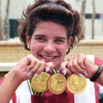 Achievement Krisztina Egerszegi holding three of her five Olympic Gold medals. Photo by Alchetron. of Krisztina Egerszegi